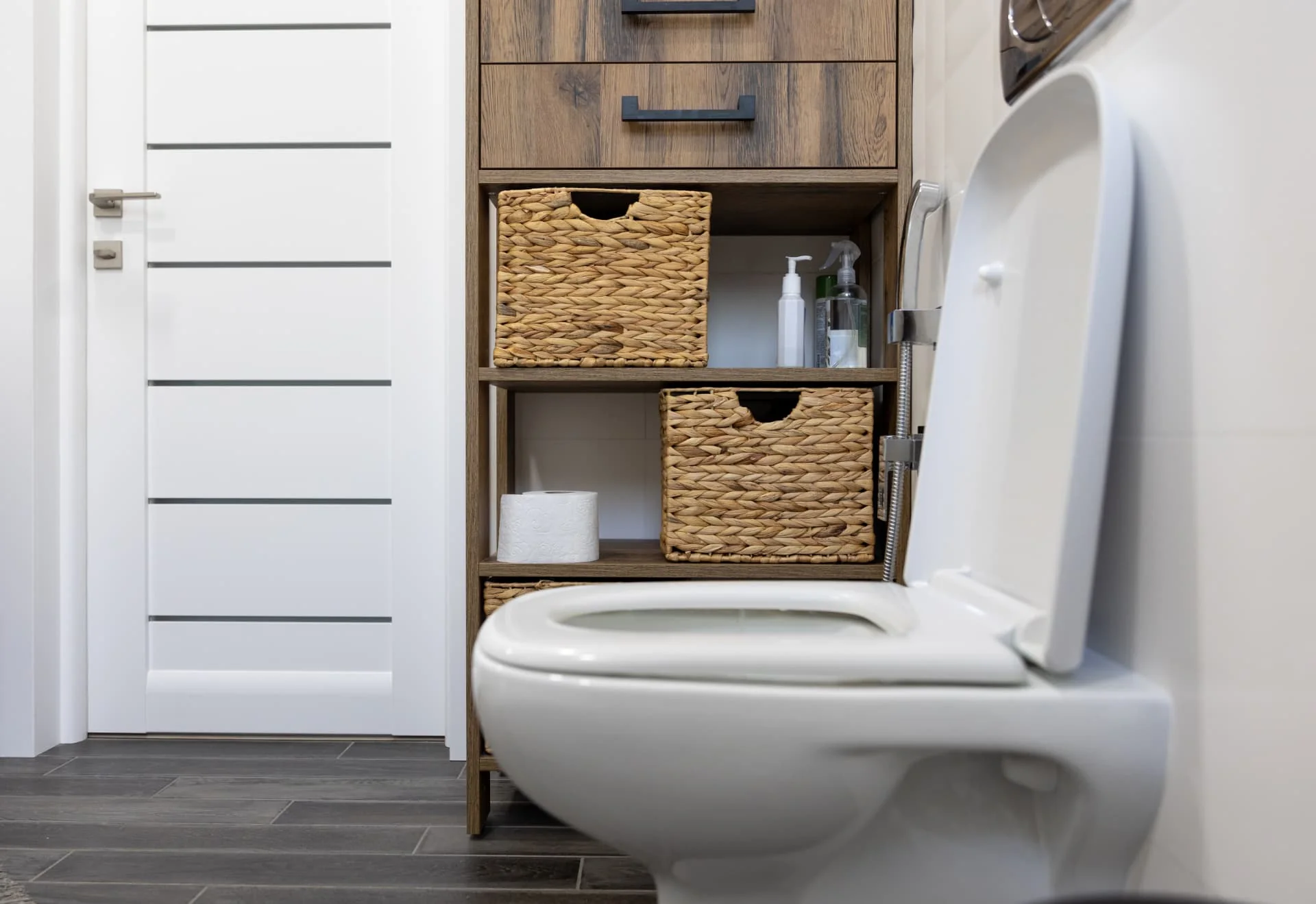 Finished downstairs cloakroom with a wall hung toilet and storage shelving in Whitley Bay